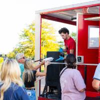 People grabbing food from Bonhomie Catering food truck.